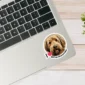 An image of an otterhound sticker placed on the bottom right corner of a laptop. The sticker features an illustration of an otterhound's face, and I love otterhounds is printed alongside with the word 'love' being represented with a red heart.