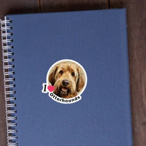 An image of an otterhound sticker on the cover of a blue notebook.