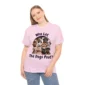 Woman wearing a pink t-shirt featuring several dogs pouting, with the text, 'Who Let The Dogs Pout?'
